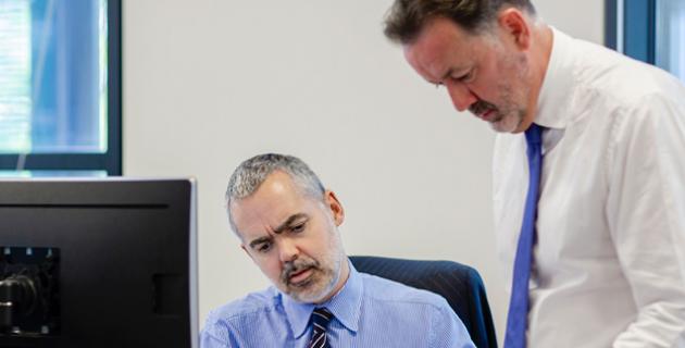 Two people at desk